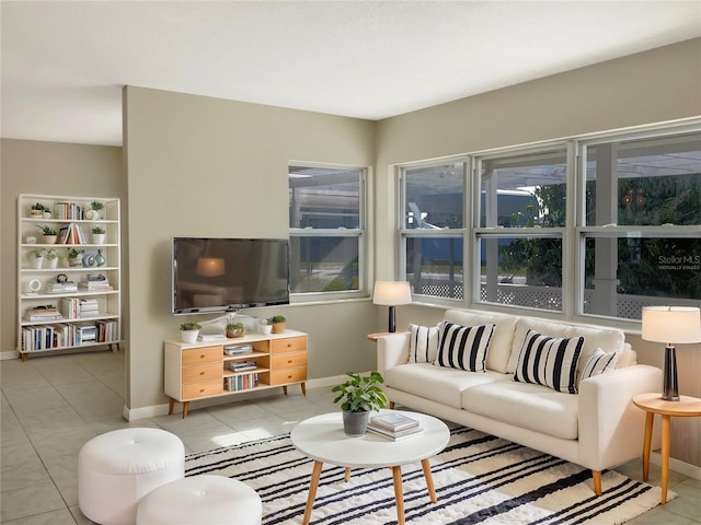 tiled living room featuring baseboards