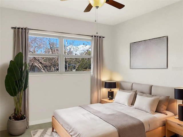 bedroom featuring ceiling fan and baseboards