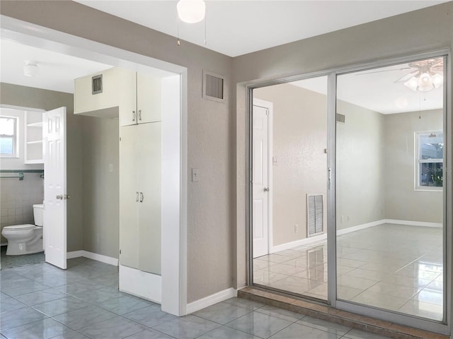 bathroom featuring toilet, visible vents, and a ceiling fan