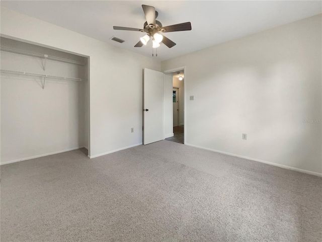 unfurnished bedroom featuring a closet, carpet flooring, visible vents, and baseboards