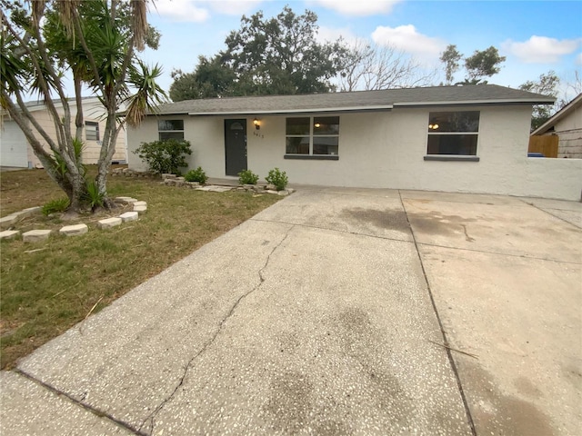 single story home with roof with shingles and stucco siding