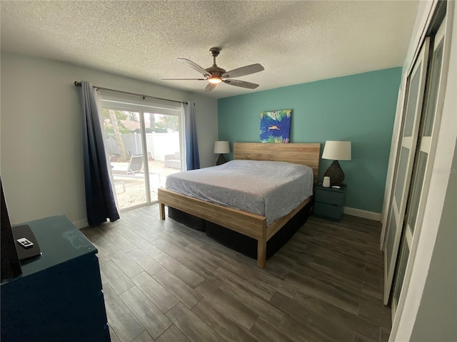 bedroom featuring a textured ceiling, wood finished floors, a ceiling fan, baseboards, and access to outside