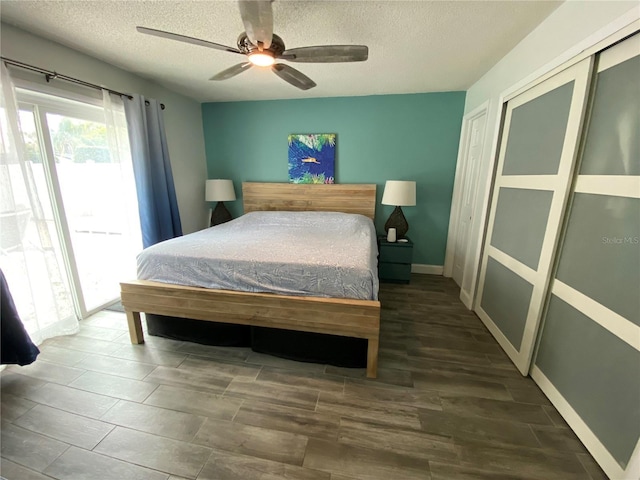 bedroom featuring a textured ceiling, a ceiling fan, access to exterior, baseboards, and a closet