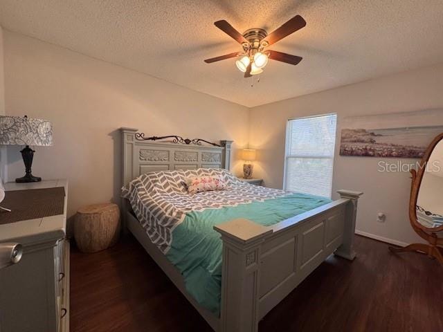 bedroom featuring a textured ceiling, dark wood-style flooring, a ceiling fan, and baseboards