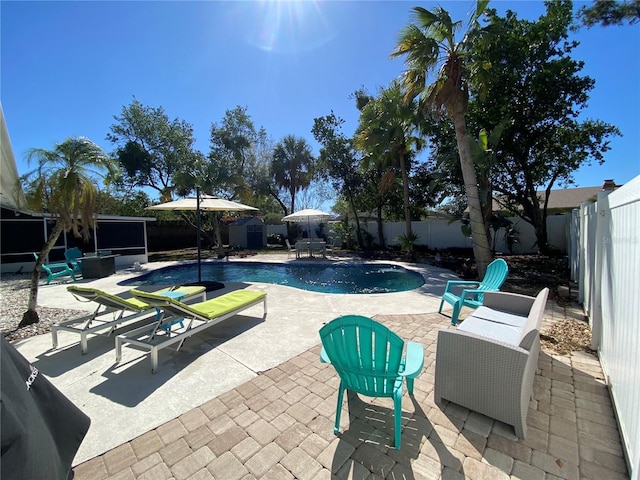 view of swimming pool with a storage shed, a fenced in pool, a patio, a fenced backyard, and an outbuilding