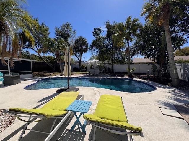 view of swimming pool featuring a patio area, a fenced backyard, and a fenced in pool