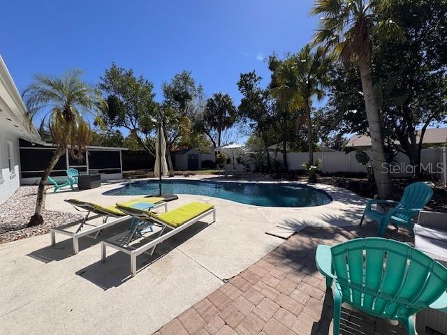 view of pool featuring a fenced backyard, a fenced in pool, and a patio