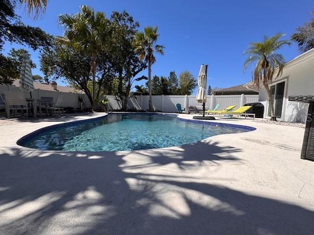 view of pool featuring a fenced backyard, a fenced in pool, and a patio