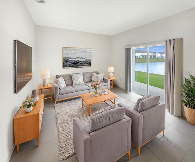 living room with a water view and visible vents