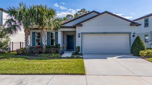 ranch-style house with stucco siding, concrete driveway, fence, a garage, and a front lawn