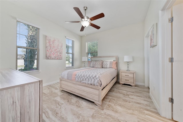 bedroom with ceiling fan and baseboards