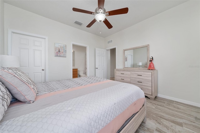 bedroom with a ceiling fan, ensuite bath, visible vents, and baseboards