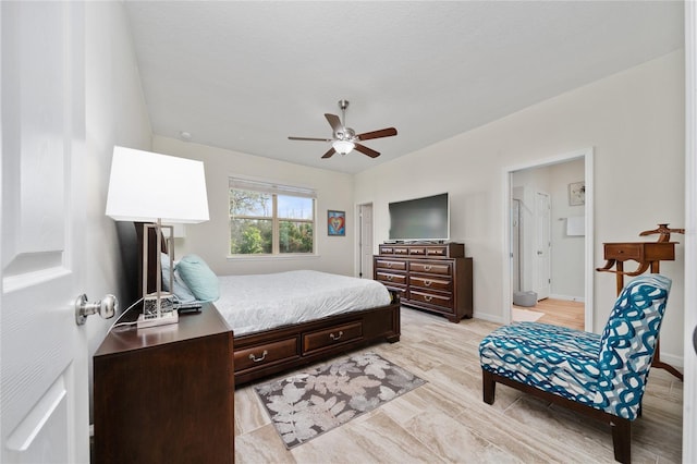 bedroom with light wood-style floors, ceiling fan, and baseboards