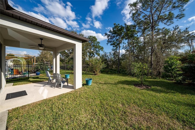 view of yard featuring a ceiling fan, a patio area, and fence