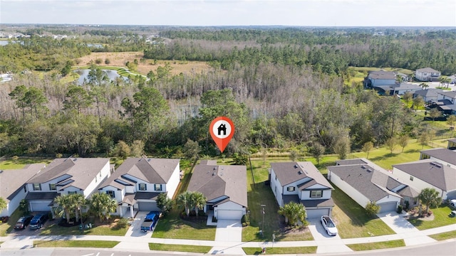 aerial view with a residential view and a view of trees