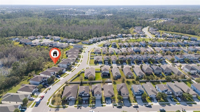 birds eye view of property featuring a residential view and a view of trees