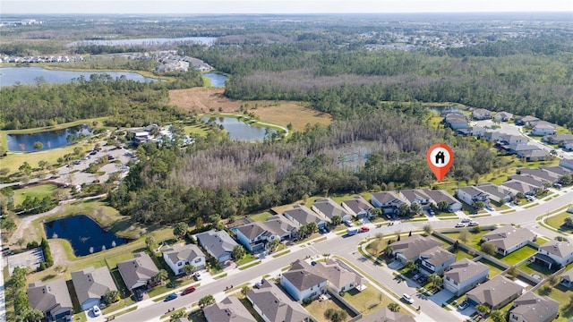 aerial view with a residential view, a water view, and a wooded view