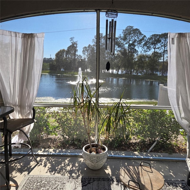 unfurnished sunroom featuring a water view