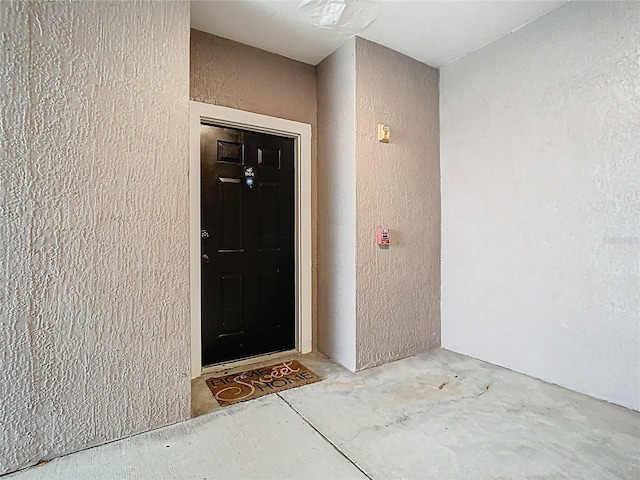 view of exterior entry with stucco siding