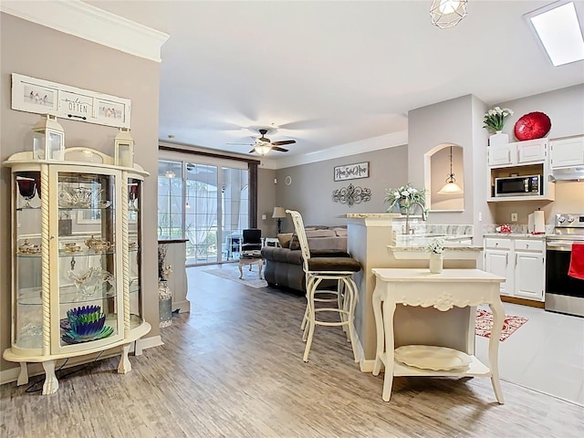 interior space with ornamental molding, light countertops, appliances with stainless steel finishes, and a sink