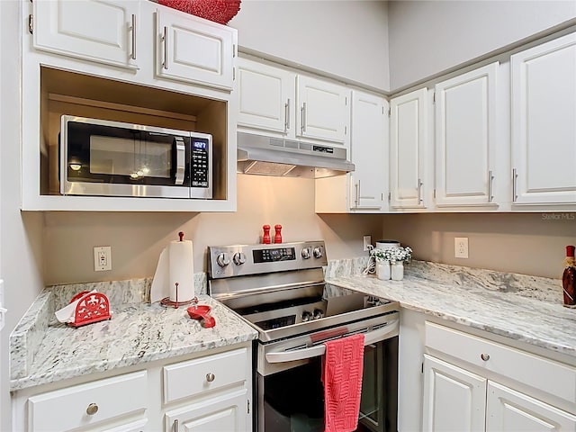 kitchen with stainless steel appliances, white cabinetry, under cabinet range hood, and light stone countertops