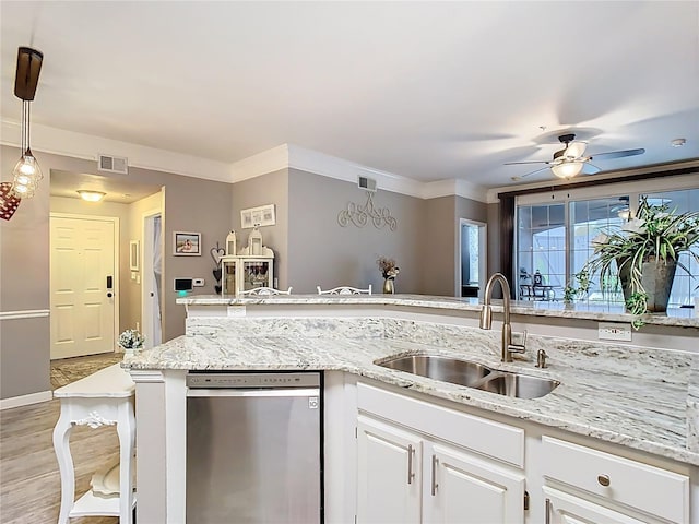 kitchen with a sink, visible vents, white cabinetry, ornamental molding, and dishwasher