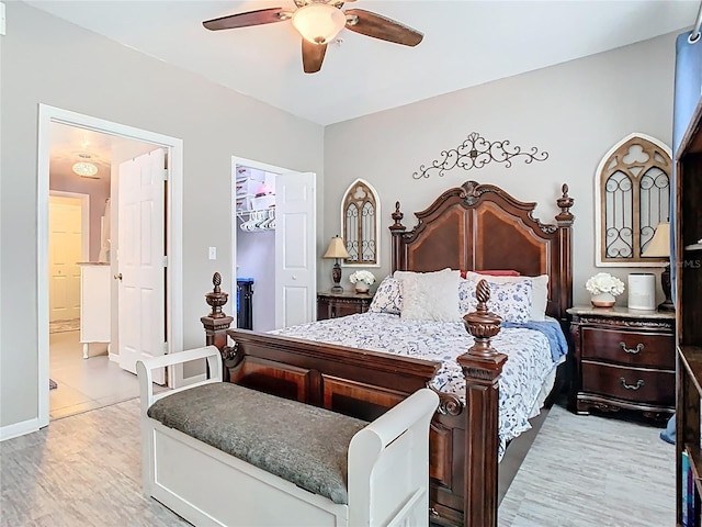 bedroom with ensuite bathroom, ceiling fan, light wood-style flooring, a spacious closet, and a closet