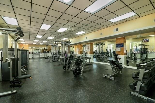 gym with a drop ceiling and visible vents