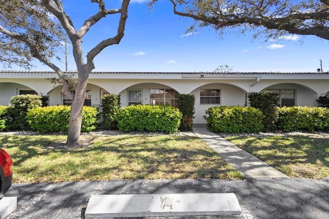 11200 102nd Ave Unit 74, Seminole, FL 33778 - view of front of home featuring stucco siding and a front lawn