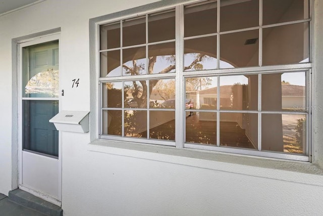 view of exterior entry featuring stucco siding