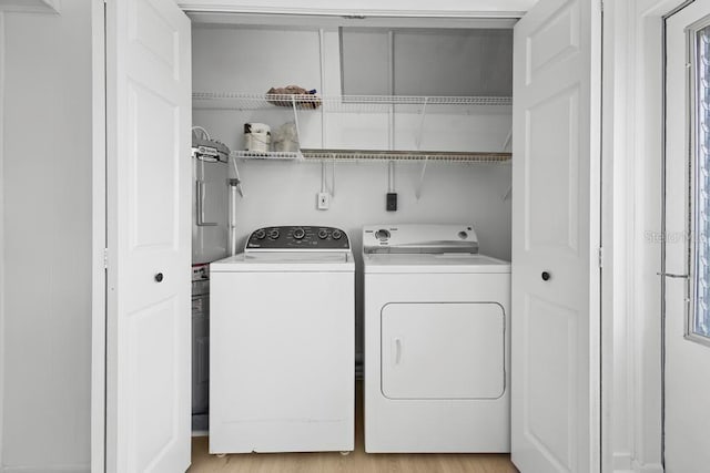 laundry room featuring laundry area, light wood-style floors, and washer and dryer