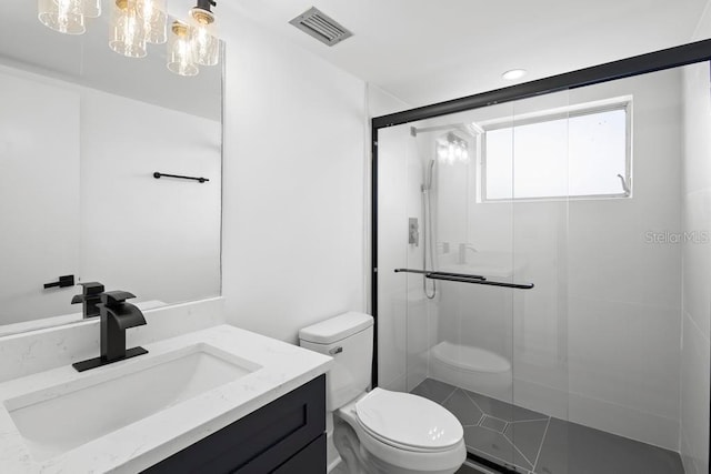 bathroom with toilet, a shower stall, visible vents, and vanity