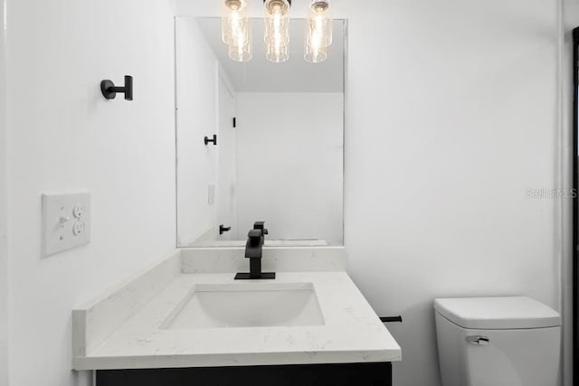 half bathroom with toilet and vanity