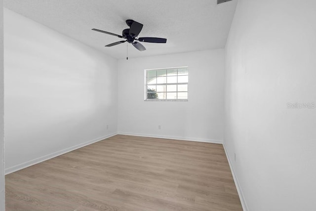 unfurnished room featuring visible vents, baseboards, a ceiling fan, a textured ceiling, and light wood-type flooring