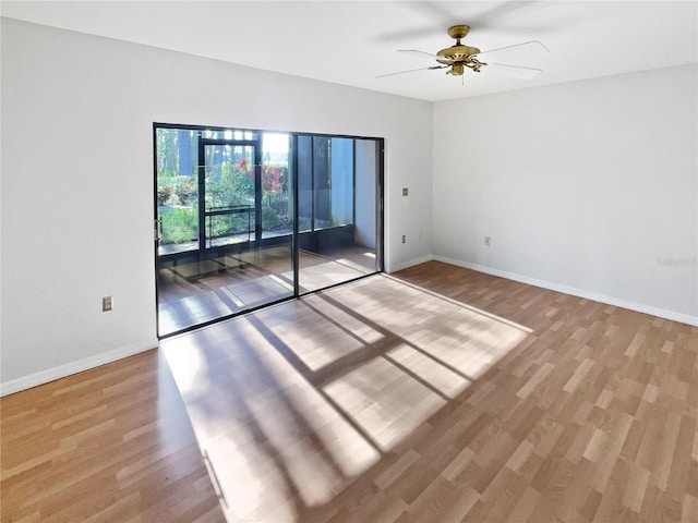 spare room with ceiling fan, baseboards, and wood finished floors