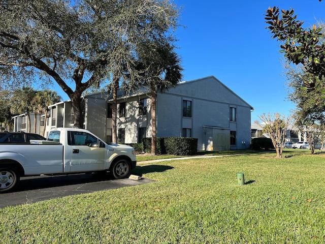 view of home's exterior with a lawn and stucco siding