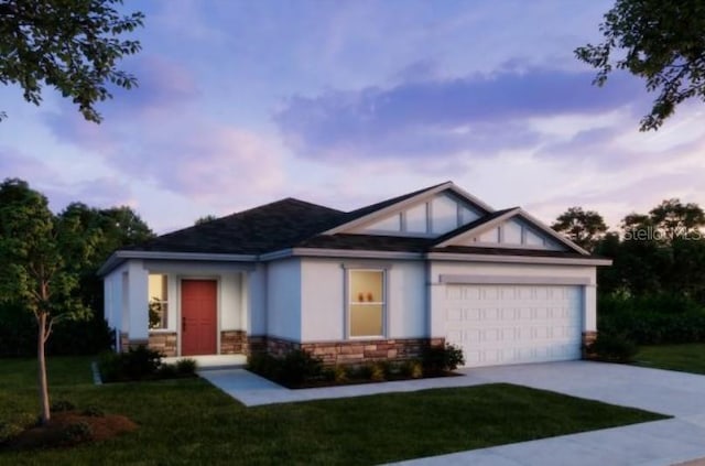 view of front of property featuring a garage, a yard, concrete driveway, and stucco siding