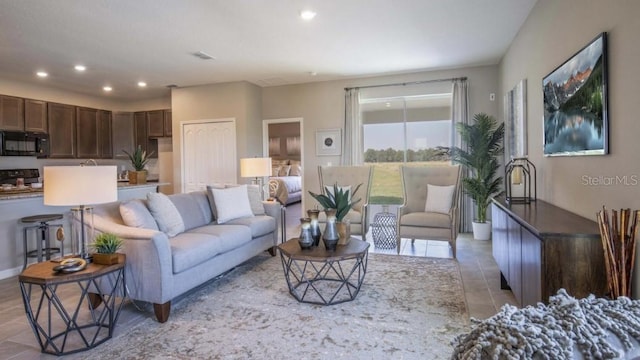 living room with light tile patterned flooring and recessed lighting