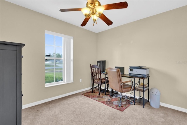 office space featuring a ceiling fan, baseboards, and carpet flooring