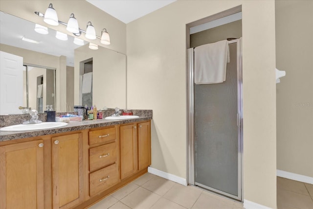 full bathroom featuring a stall shower, tile patterned flooring, and a sink