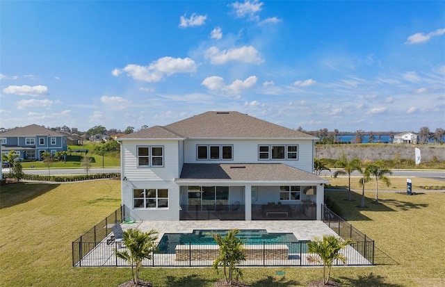 rear view of house with a patio area, a fenced backyard, a fenced in pool, and a lawn