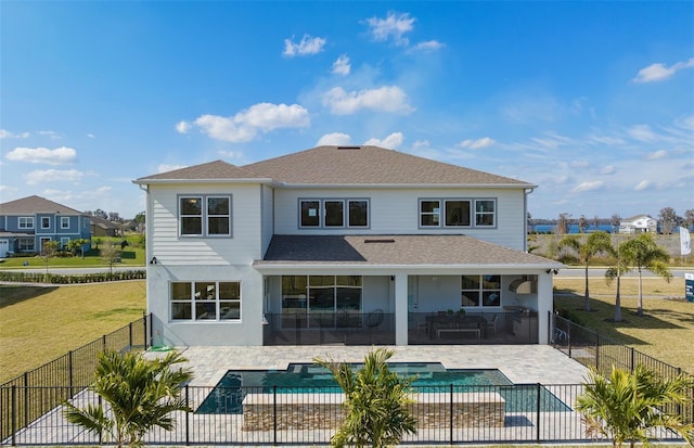 rear view of house with a patio, a yard, a fenced backyard, and a fenced in pool