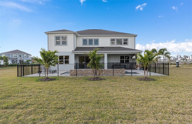 rear view of property featuring a patio, fence, and a lawn