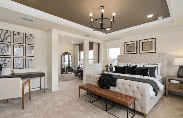 carpeted bedroom with visible vents, multiple windows, a tray ceiling, and a notable chandelier