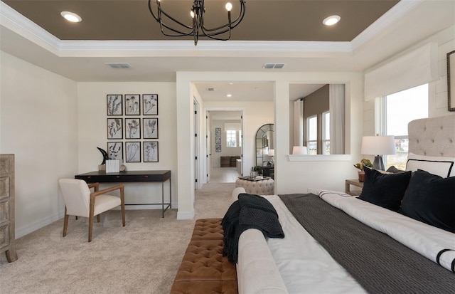 bedroom with crown molding, a tray ceiling, visible vents, and light colored carpet