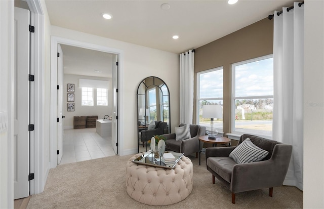 sitting room featuring light carpet, baseboards, light tile patterned flooring, and recessed lighting