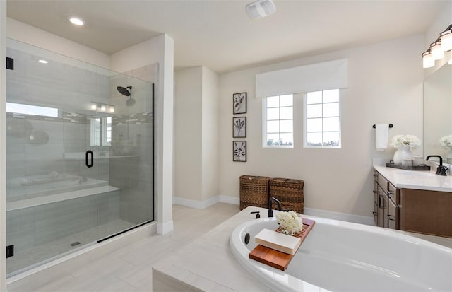 full bath with a stall shower, baseboards, vanity, a bath, and recessed lighting