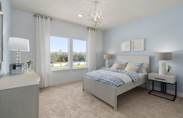 bedroom featuring light carpet, baseboards, and a notable chandelier