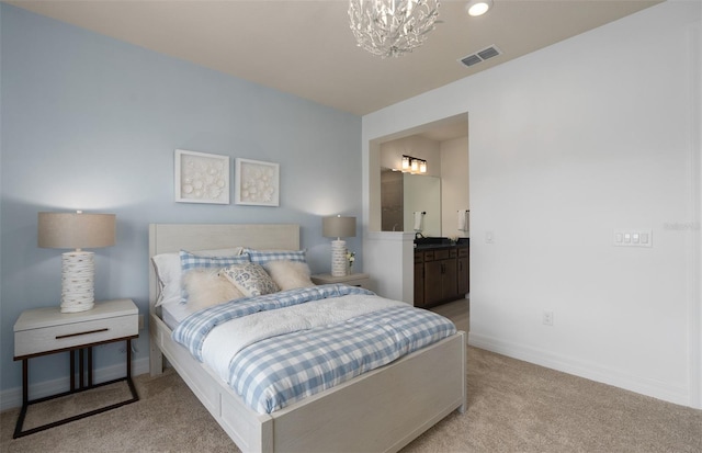 bedroom with a chandelier, connected bathroom, visible vents, baseboards, and carpet