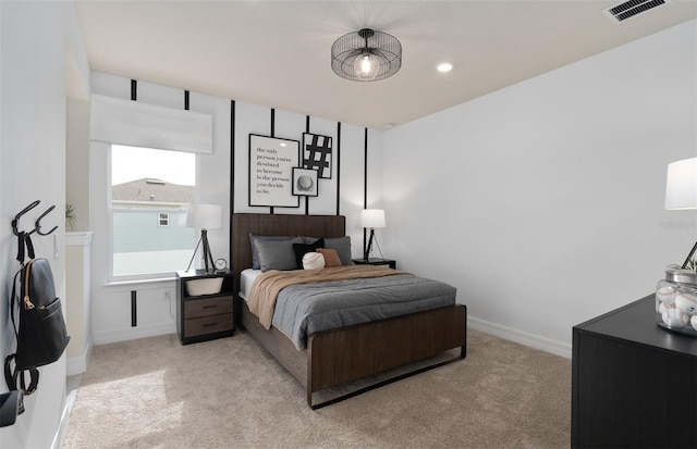 bedroom with light carpet, visible vents, and baseboards